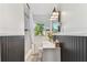 Well-lit bathroom featuring black and white tile flooring and wainscoting, and a shower-tub combination at 1046 Yale N St, St Petersburg, FL 33713