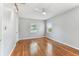 Bedroom featuring polished wood floors, white ceiling fan, and natural light at 1046 Yale N St, St Petersburg, FL 33713