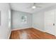 Bedroom features hardwood floors, neutral walls, a ceiling fan, and natural light from the window at 1046 Yale N St, St Petersburg, FL 33713