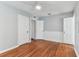Bedroom featuring hardwood floors, baseboard molding, and white doors leading to closets and ensuite at 1046 Yale N St, St Petersburg, FL 33713