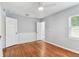 Spacious bedroom with hardwood floors and neutral walls, and an ensuite bathroom at 1046 Yale N St, St Petersburg, FL 33713