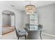 Stylish dining room featuring a glass table, modern light fixture and natural light at 1046 Yale N St, St Petersburg, FL 33713