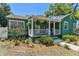 View of home's covered front porch, landscaping and porch seating at 1046 Yale N St, St Petersburg, FL 33713