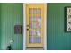 Close up of a yellow front door, mail box, and house numbers at 1046 Yale N St, St Petersburg, FL 33713