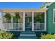 A cozy covered front porch with seating and hanging ferns at 1046 Yale N St, St Petersburg, FL 33713