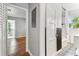 Hallway with white trim and doors, leading to a view of a bathroom and other living spaces at 1046 Yale N St, St Petersburg, FL 33713