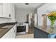 Bright kitchen featuring stainless steel appliances, tile accents, and white cabinetry at 1046 Yale N St, St Petersburg, FL 33713