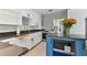 Bright kitchen featuring white cabinets, an island with seating, and stainless steel appliances at 1046 Yale N St, St Petersburg, FL 33713