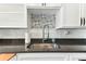 Bright kitchen featuring white cabinets and an undermounted stainless steel sink at 1046 Yale N St, St Petersburg, FL 33713