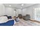 Cozy living room featuring hardwood floors, accent chairs, and a comfortable blue sofa at 1046 Yale N St, St Petersburg, FL 33713
