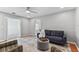 Open-concept living room with hardwood floors and a comfortable blue sofa and accent chairs at 1046 Yale N St, St Petersburg, FL 33713