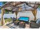 Comfortable outdoor seating area featuring a gazebo with stylish wicker furniture and bright blue cushions at 1046 Yale N St, St Petersburg, FL 33713