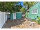 Backyard shed with quaint white door, complemented by an outdoor sink and worktable at 1046 Yale N St, St Petersburg, FL 33713