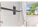 Shower and tub featuring white subway tile with black accent stripe and recessed niche shelving at 1046 Yale N St, St Petersburg, FL 33713