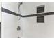 Modern shower space featuring white subway tile with a black accent stripe and recessed niche at 1046 Yale N St, St Petersburg, FL 33713