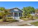 Charming home with lush landscaping, inviting porch, and classic architectural details at 107 W Amelia Ave, Tampa, FL 33602