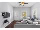 Comfortable living room featuring a large sectional sofa, a ceiling fan and a large window for natural light at 107 W Amelia Ave, Tampa, FL 33602