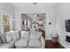 Comfortable living room with hardwood floors, a large sectional sofa and a basket for extra storage at 107 W Amelia Ave, Tampa, FL 33602