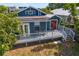 Charming home featuring a spacious deck and inviting red doors, perfect for outdoor entertaining at 107 W Amelia Ave, Tampa, FL 33602