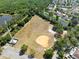 Drone shot of community baseball field, showing adjacent neighborhood, parking, and treeline at 11503 Whispering Hollow Dr, Tampa, FL 33635