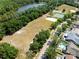 Aerial view showcasing a large community field, tennis courts, and a neighborhood pool for residents at 11503 Whispering Hollow Dr, Tampa, FL 33635