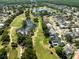 Scenic aerial view of a golf course community with lush greenery, ponds, and well-maintained homes at 11503 Whispering Hollow Dr, Tampa, FL 33635