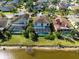 Aerial shot of homes with screened pools and lush greenery near the water at 11503 Whispering Hollow Dr, Tampa, FL 33635