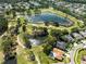 Overhead shot of a golf course community featuring a large pond, manicured greens, and beautiful residential properties at 11503 Whispering Hollow Dr, Tampa, FL 33635