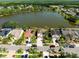 An aerial view showing waterfront homes with palm trees and well-manicured lawns near a picturesque lake at 11503 Whispering Hollow Dr, Tampa, FL 33635