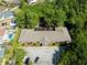 Overhead shot of a building with a rooftop playground surrounded by lush greenery and a parking area at 11503 Whispering Hollow Dr, Tampa, FL 33635