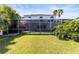 Spacious backyard with manicured lawn and mature landscaping surrounding a screened pool enclosure at 11503 Whispering Hollow Dr, Tampa, FL 33635