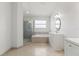 Bright bathroom with modern finishes, including a glass-enclosed shower, soaking tub, and stylish vanity at 11503 Whispering Hollow Dr, Tampa, FL 33635