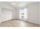 An empty bedroom featuring light wood flooring, a ceiling fan, closet and a window with a water view at 11503 Whispering Hollow Dr, Tampa, FL 33635