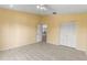Empty bedroom with laminate flooring, a ceiling fan, and an open door to the hallway at 11503 Whispering Hollow Dr, Tampa, FL 33635