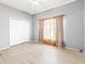 Empty bedroom features laminate flooring, a ceiling fan, and a double door closet at 11503 Whispering Hollow Dr, Tampa, FL 33635