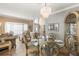 Elegant dining room featuring a crystal chandelier, large window and view to living room at 11503 Whispering Hollow Dr, Tampa, FL 33635