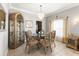 Elegant dining room with glass table, decorative chairs, and ornate hutch showcases refined living at 11503 Whispering Hollow Dr, Tampa, FL 33635