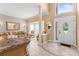 Inviting foyer featuring tile flooring, a view into the living room and dining area at 11503 Whispering Hollow Dr, Tampa, FL 33635