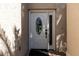Close-up of the white front door featuring an oval window, sidelight and 'welcome' mat at 11503 Whispering Hollow Dr, Tampa, FL 33635
