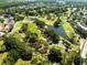 Scenic aerial view of a lush golf course with water features, mature trees, and meticulously manicured greens at 11503 Whispering Hollow Dr, Tampa, FL 33635