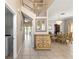 Hallway with view to dining area, decorated chest, stairs and entry to laundry area at 11503 Whispering Hollow Dr, Tampa, FL 33635