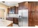 Kitchen with dark wood cabinets, granite countertops, stainless steel refrigerator, and ample storage space at 11503 Whispering Hollow Dr, Tampa, FL 33635