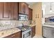 Updated kitchen with granite countertops, stainless steel appliances, and ample counter space at 11503 Whispering Hollow Dr, Tampa, FL 33635
