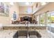 Open-concept kitchen with granite counters and a view of the double-basin sink, pool, and living area at 11503 Whispering Hollow Dr, Tampa, FL 33635