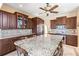Bright, open kitchen featuring custom cabinets, granite countertops, and a central island with bar stool seating at 11503 Whispering Hollow Dr, Tampa, FL 33635