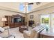 Grand living room with high ceilings, fireplace, entertainment center and comfortable seating at 11503 Whispering Hollow Dr, Tampa, FL 33635