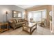 Inviting living room featuring tile floors, neutral decor, and a bay window with sheer curtains at 11503 Whispering Hollow Dr, Tampa, FL 33635