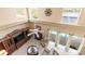 High-ceilinged living room with a fireplace, ceiling fan and bright views of the pool and water at 11503 Whispering Hollow Dr, Tampa, FL 33635