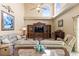 Living room with high ceilings, ceiling fan, fireplace, large entertainment center and comfortable seating at 11503 Whispering Hollow Dr, Tampa, FL 33635