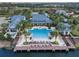 Aerial view of a community clubhouse, pool, pier, and palm trees at 12026 Medley Ter, Lakewood Ranch, FL 34211